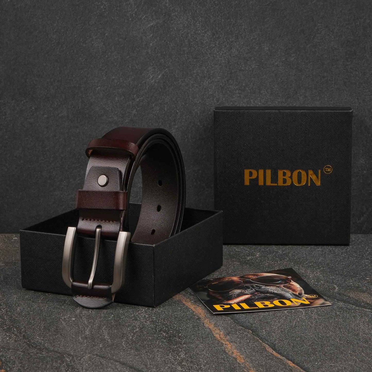 Brown leather PILBON G307 belt displayed in packaging, featuring a stainless alloy buckle and stylish design.