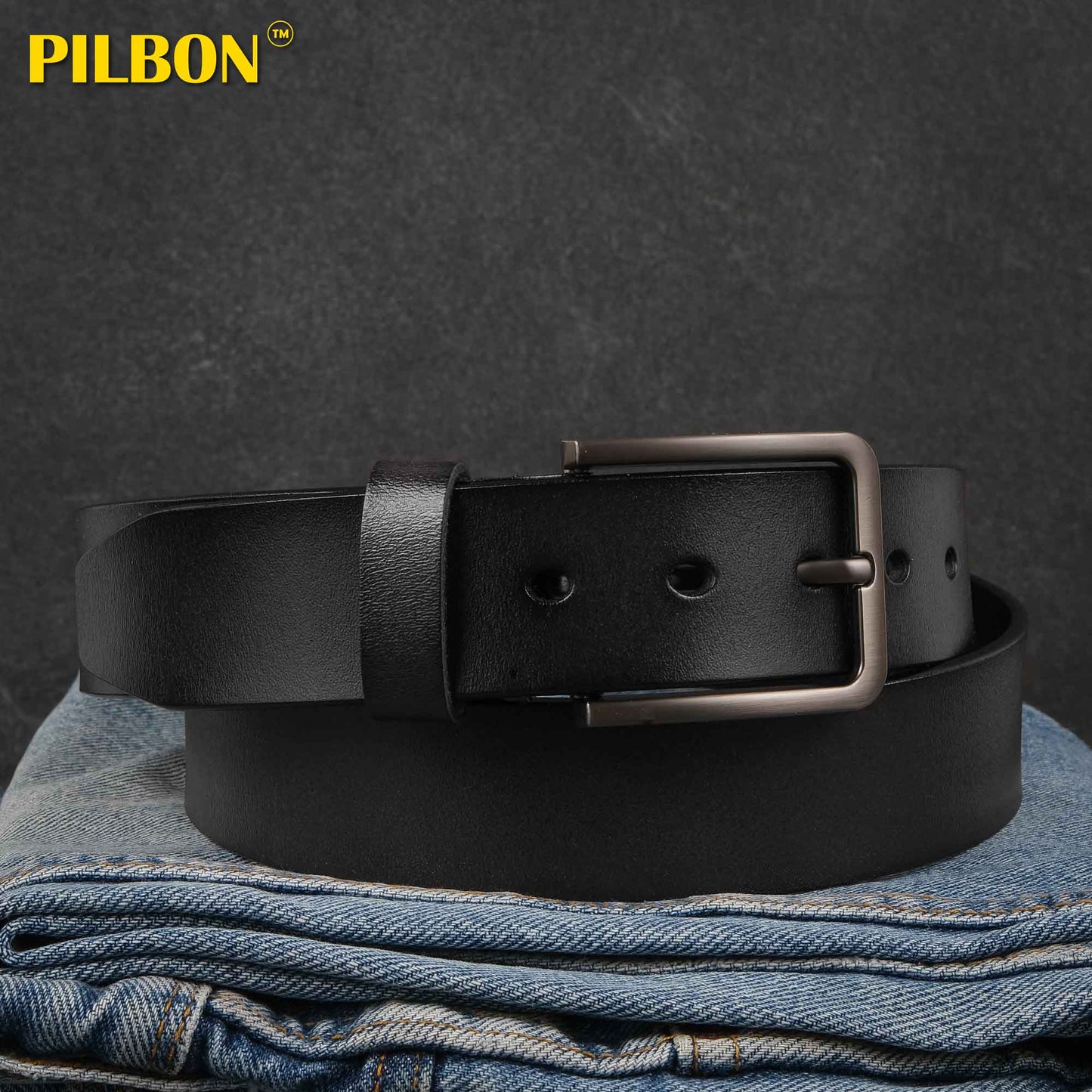 Black genuine leather belt PILBON G314 on folded jeans, showcasing its stylish design and durable stainless alloy buckle.